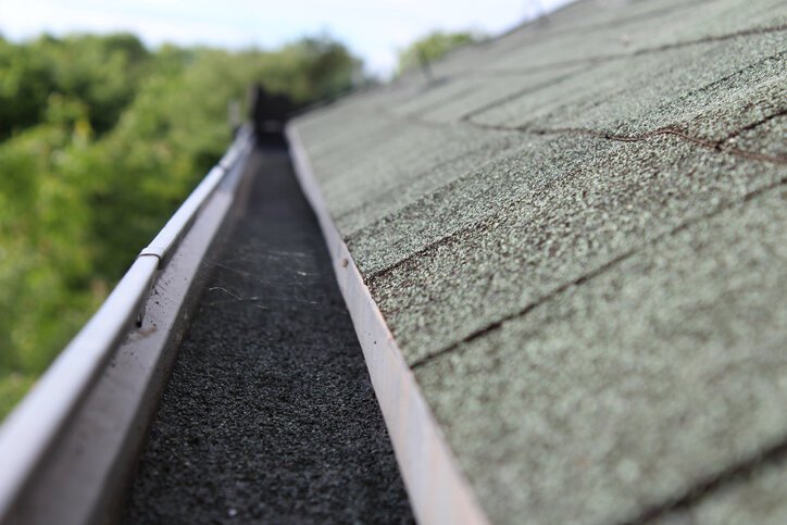 Full rain gutter on roof