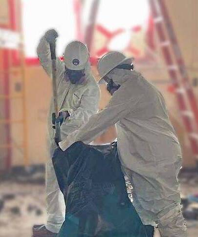 abatement crew members preparing material for proper disposal